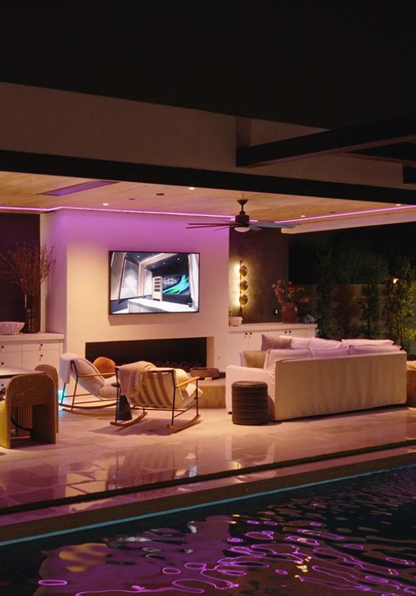 Modern patio with a waterfall feature dropping into a swimming pool